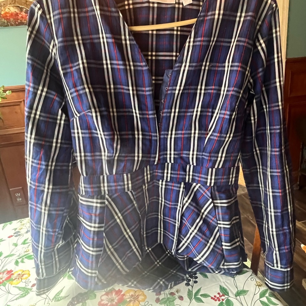 Plaid top with fitted waist.